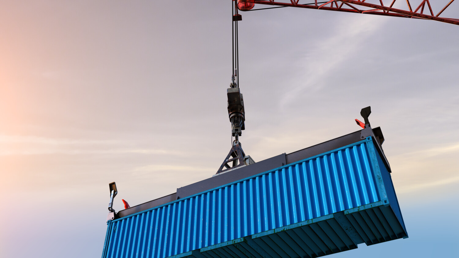 Crane lifting container in port.