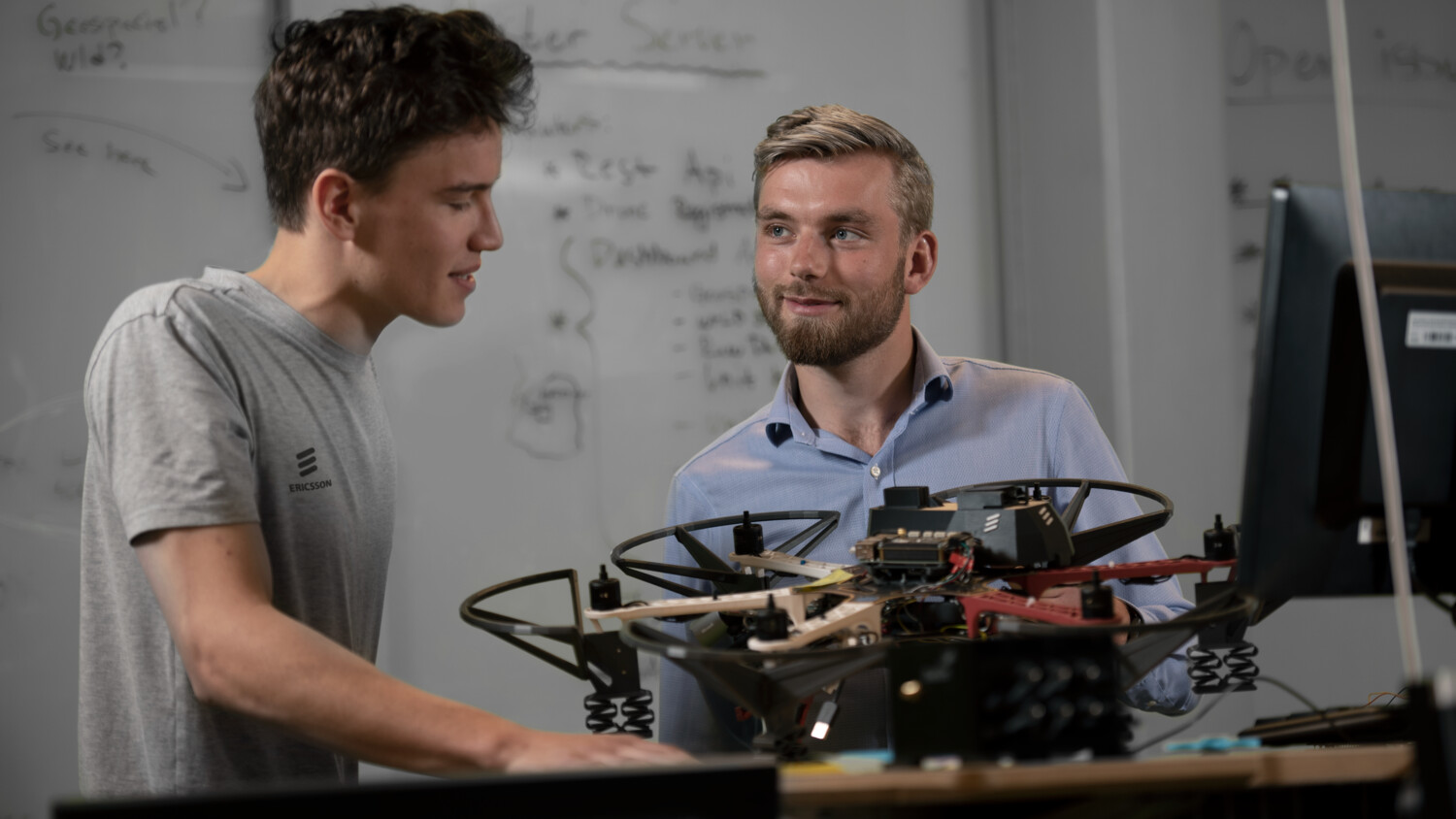 Colleagues in lab with IoT connected device
