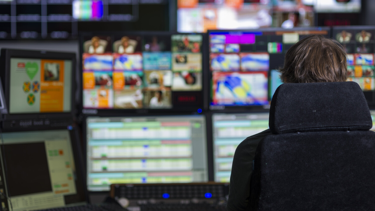 Person in front of screens