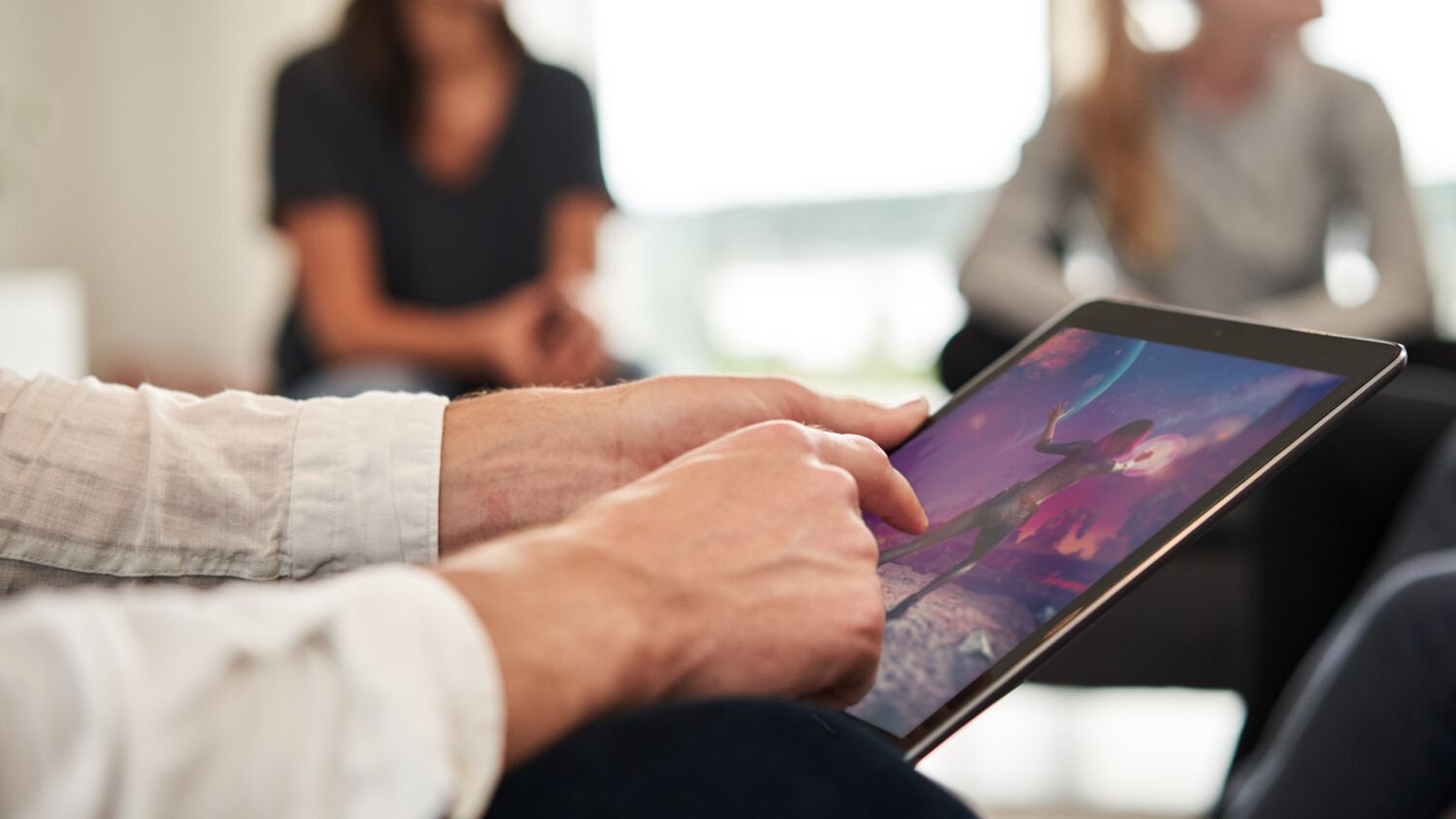 Group of people with multiple screens at home
