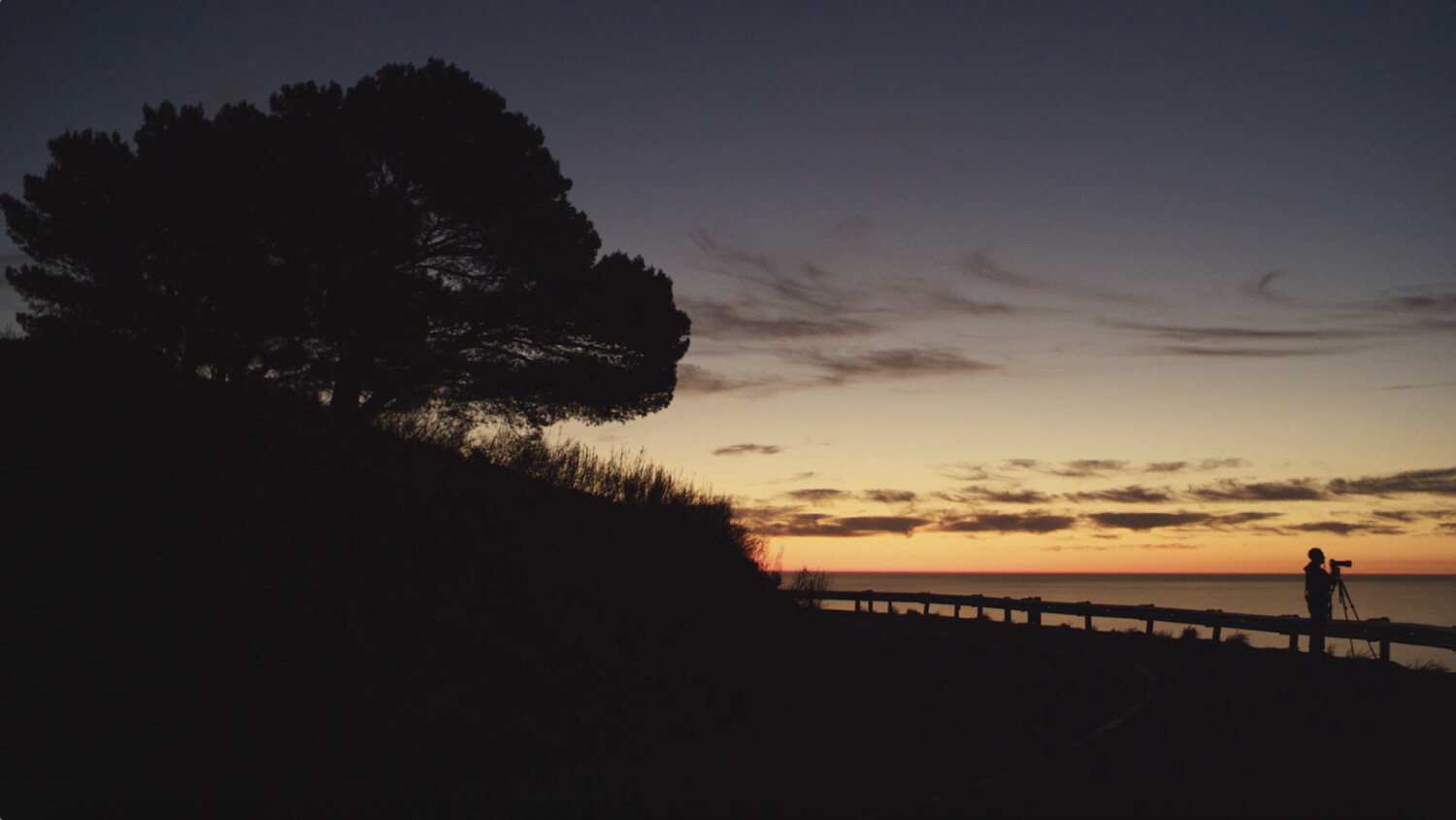 Photographer capturing landscape at dusk