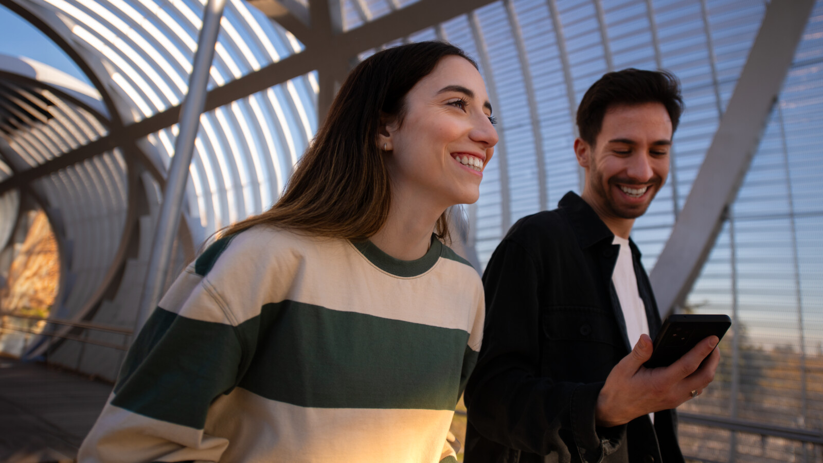 Couple walking with tablet.