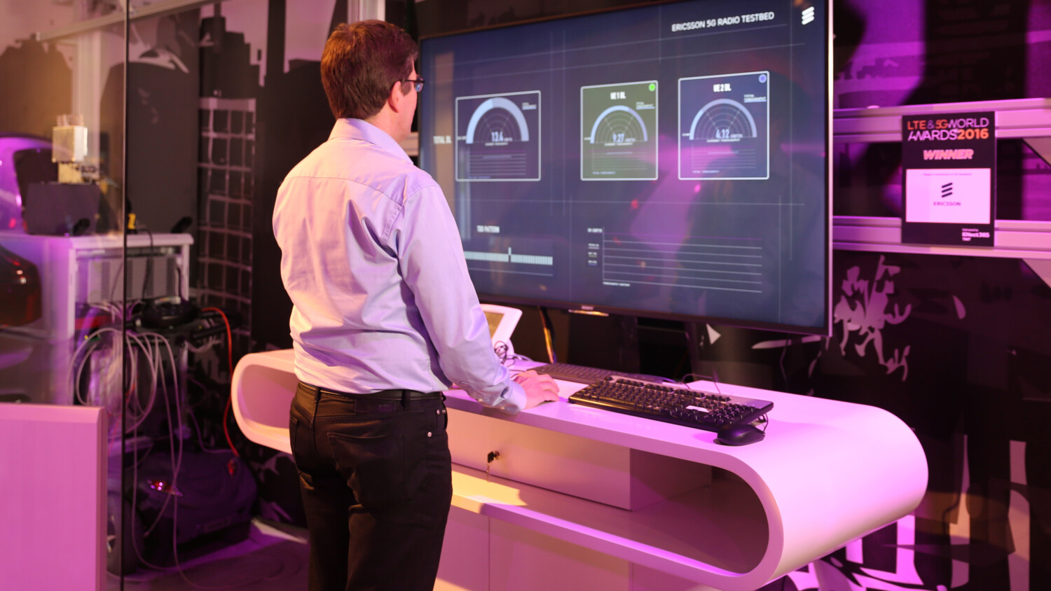 man in front of a large screen