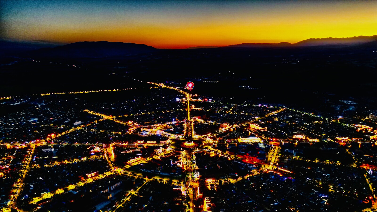 Aerial view of city lights at twilight.