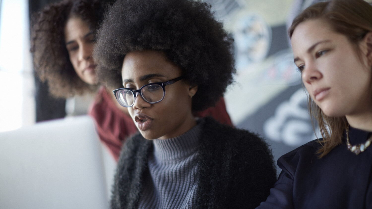 Women working, closeup of them at a computer