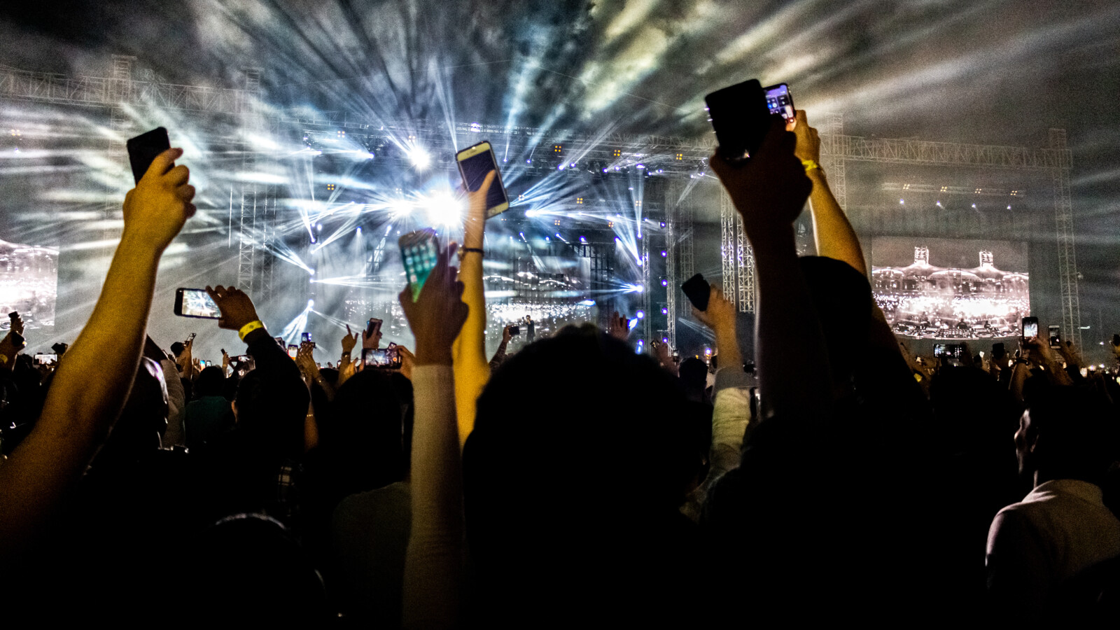 Concert audience recording with phones under stage lights