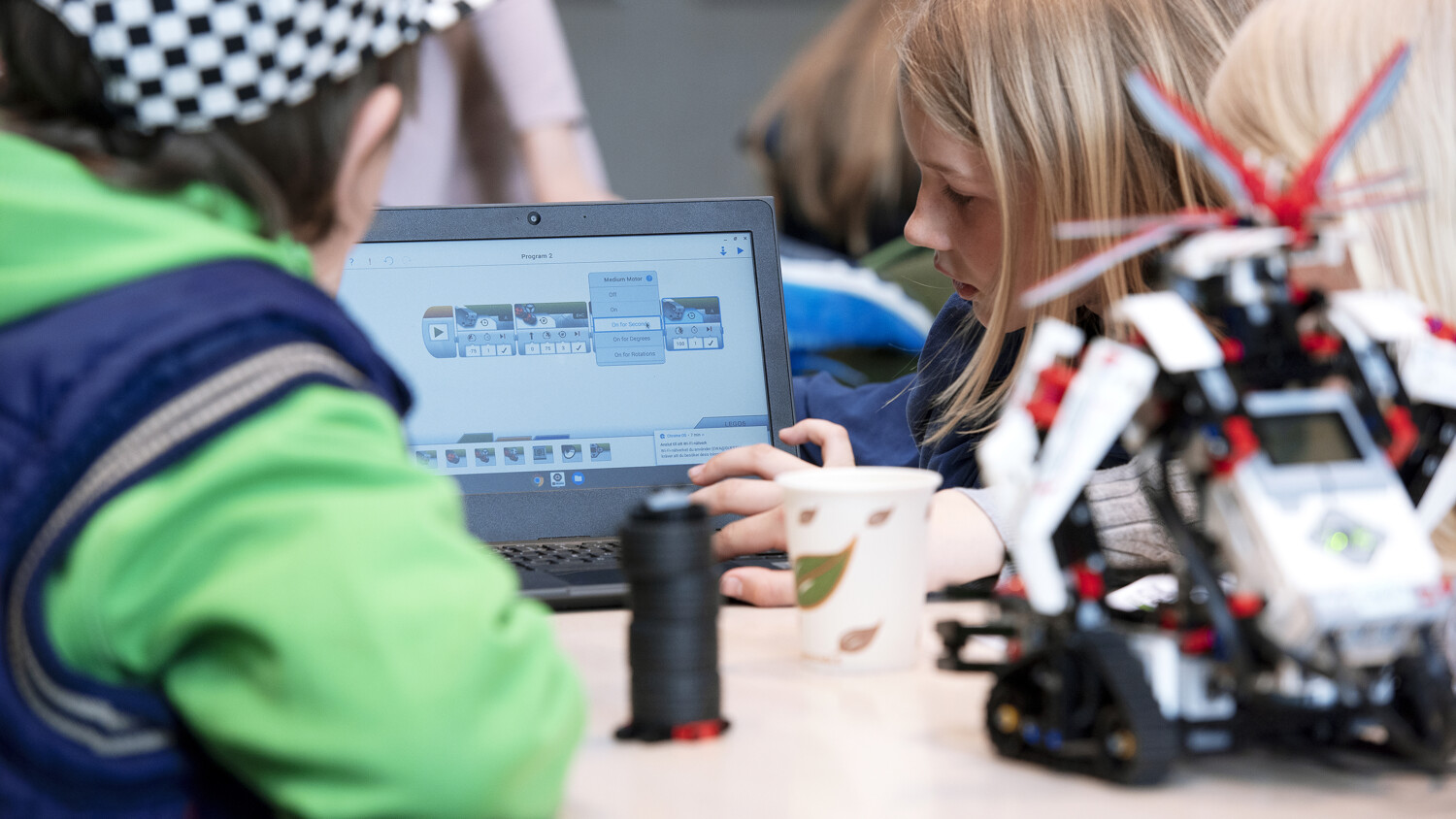 Kids looking at a tablet.