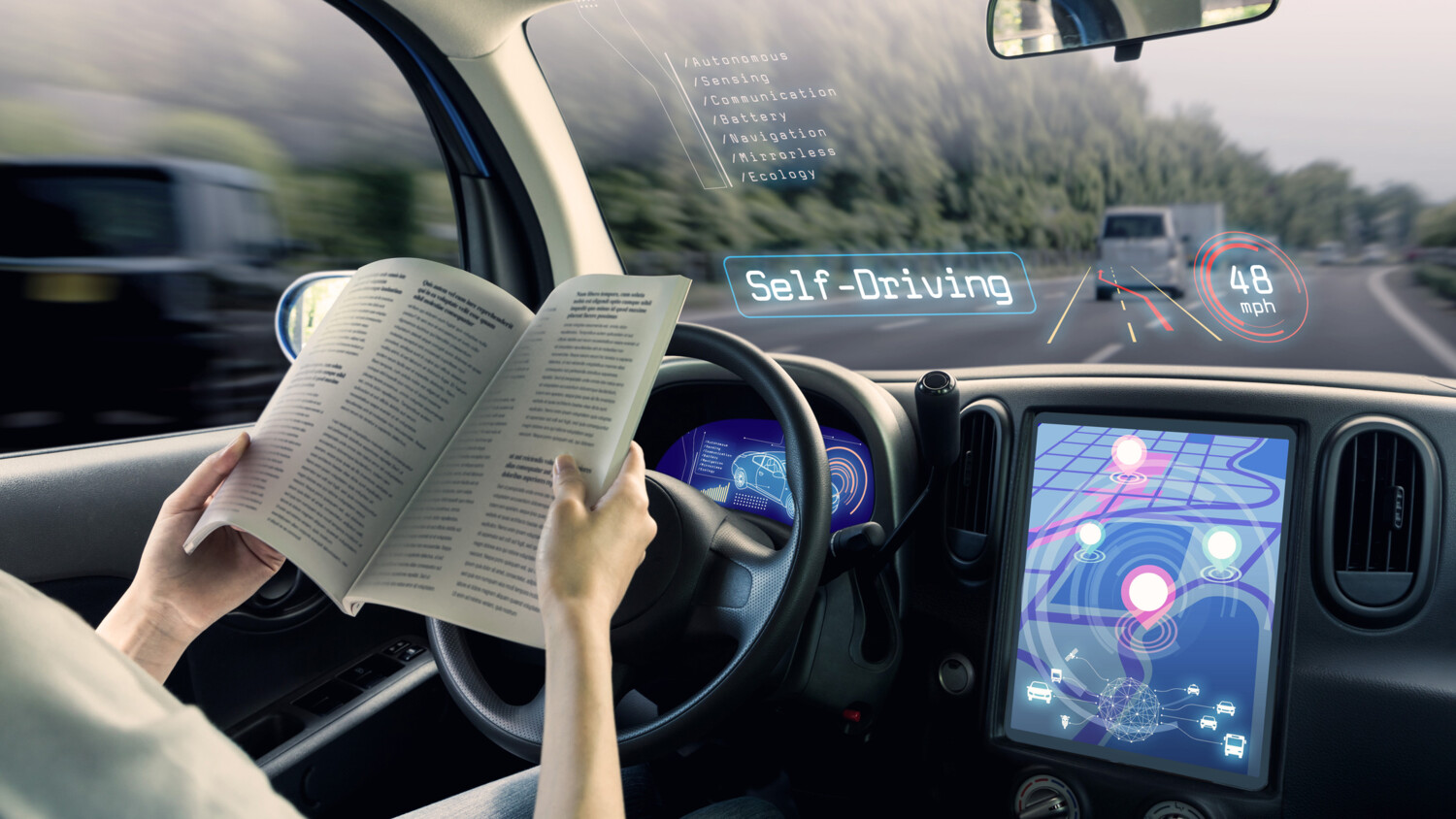 A person reading a book in a self-driving car.