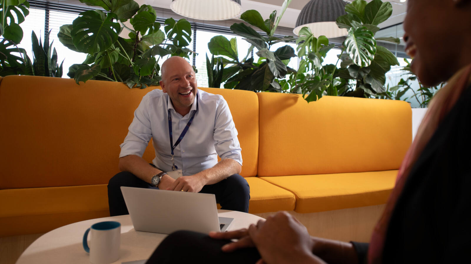 A group of coworkers talking in a lounge area