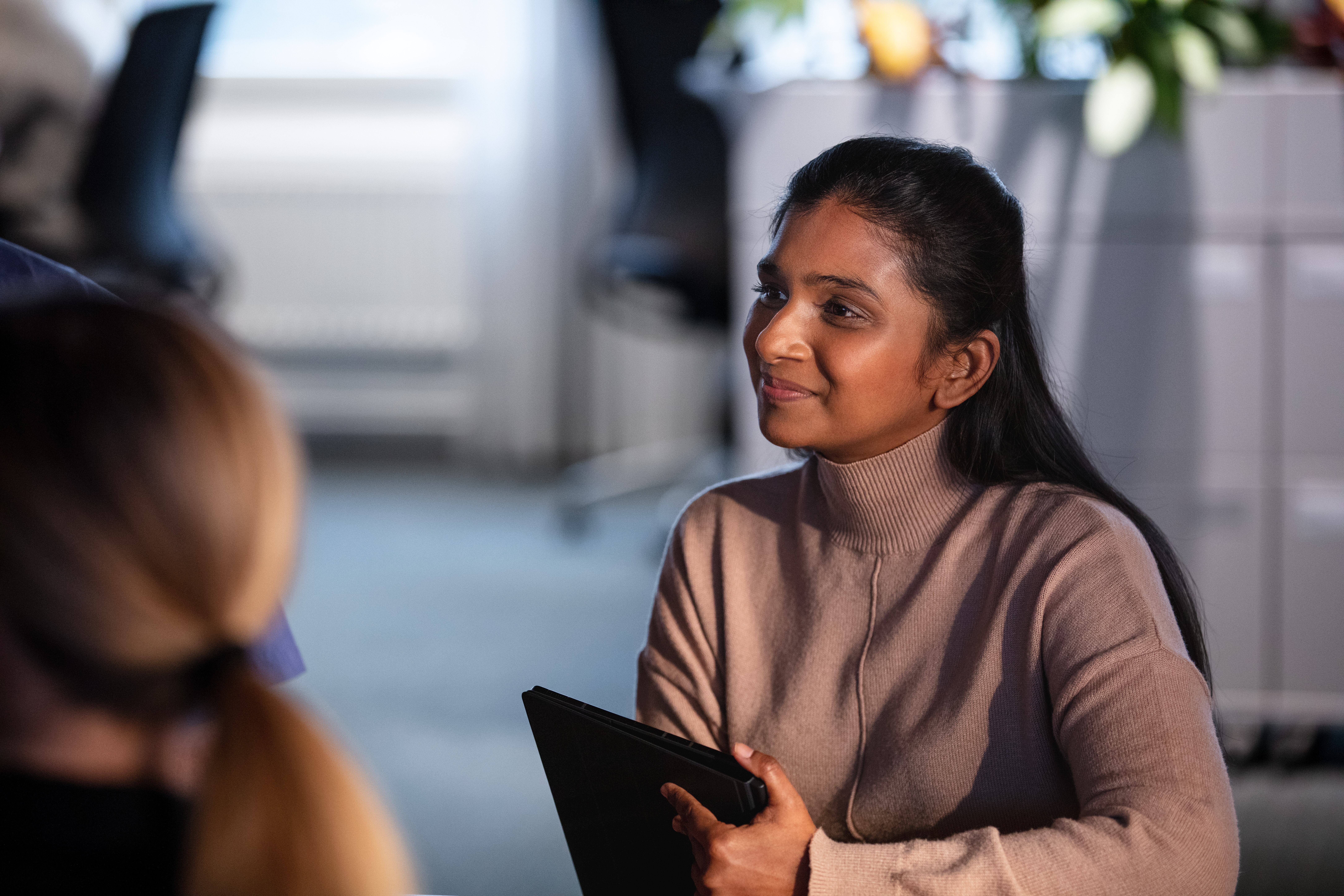 A female professional seen with a device at work