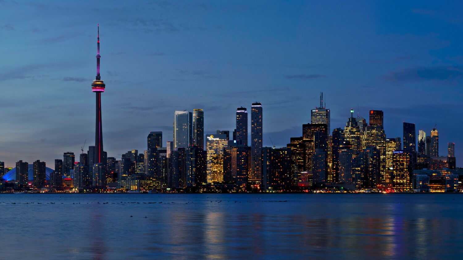 blue city with red lighthouse