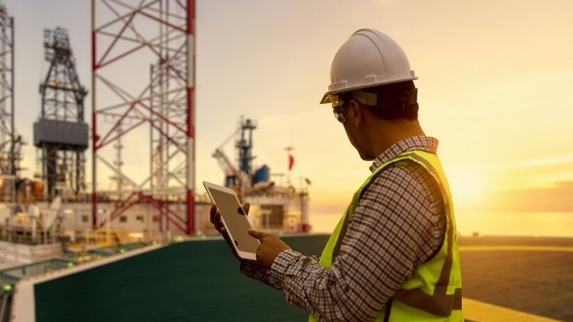 Engineer on a oil rig with a tablet.