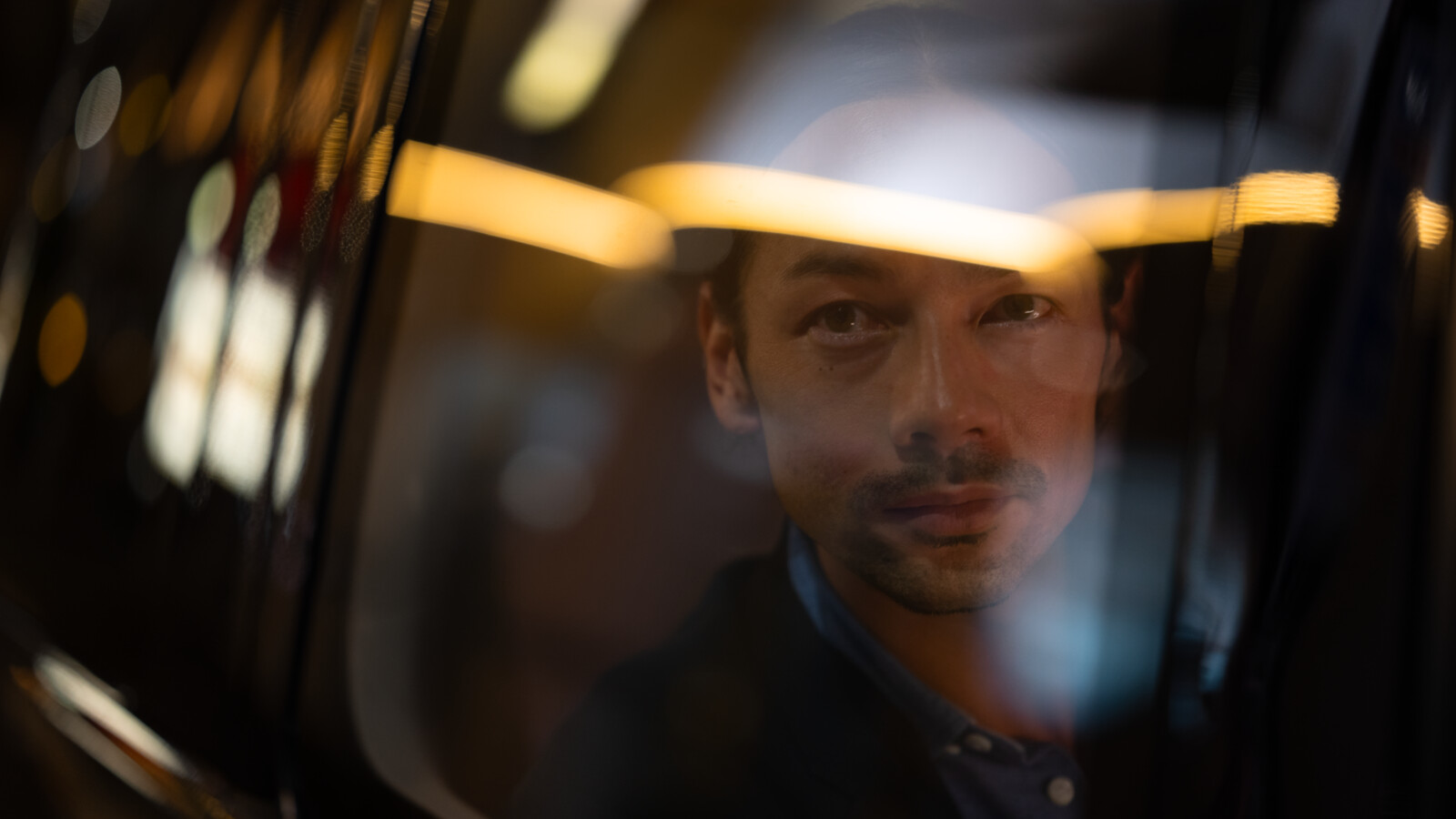 Man looking out the window from a taxi