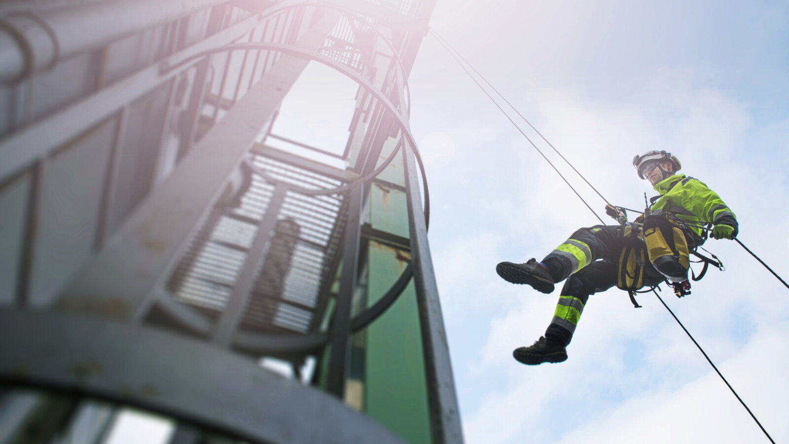 Worker safety Technician hanging from radio mast