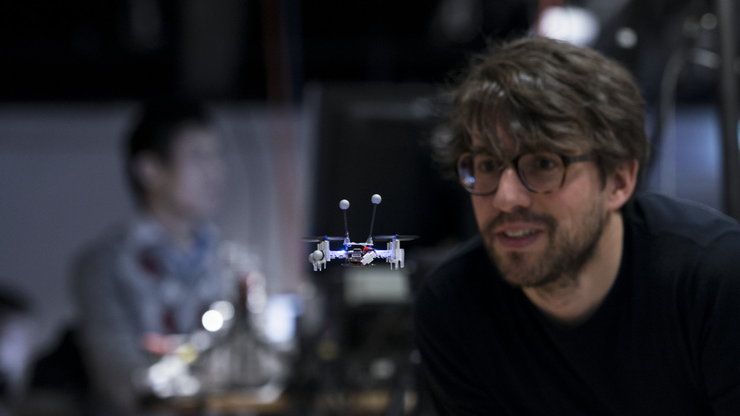 Man looking at a small drone