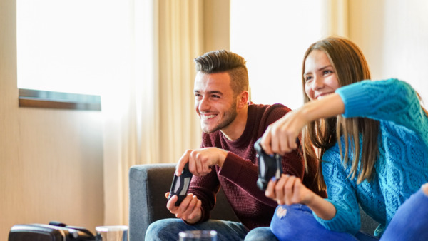 Two young adults playing video games