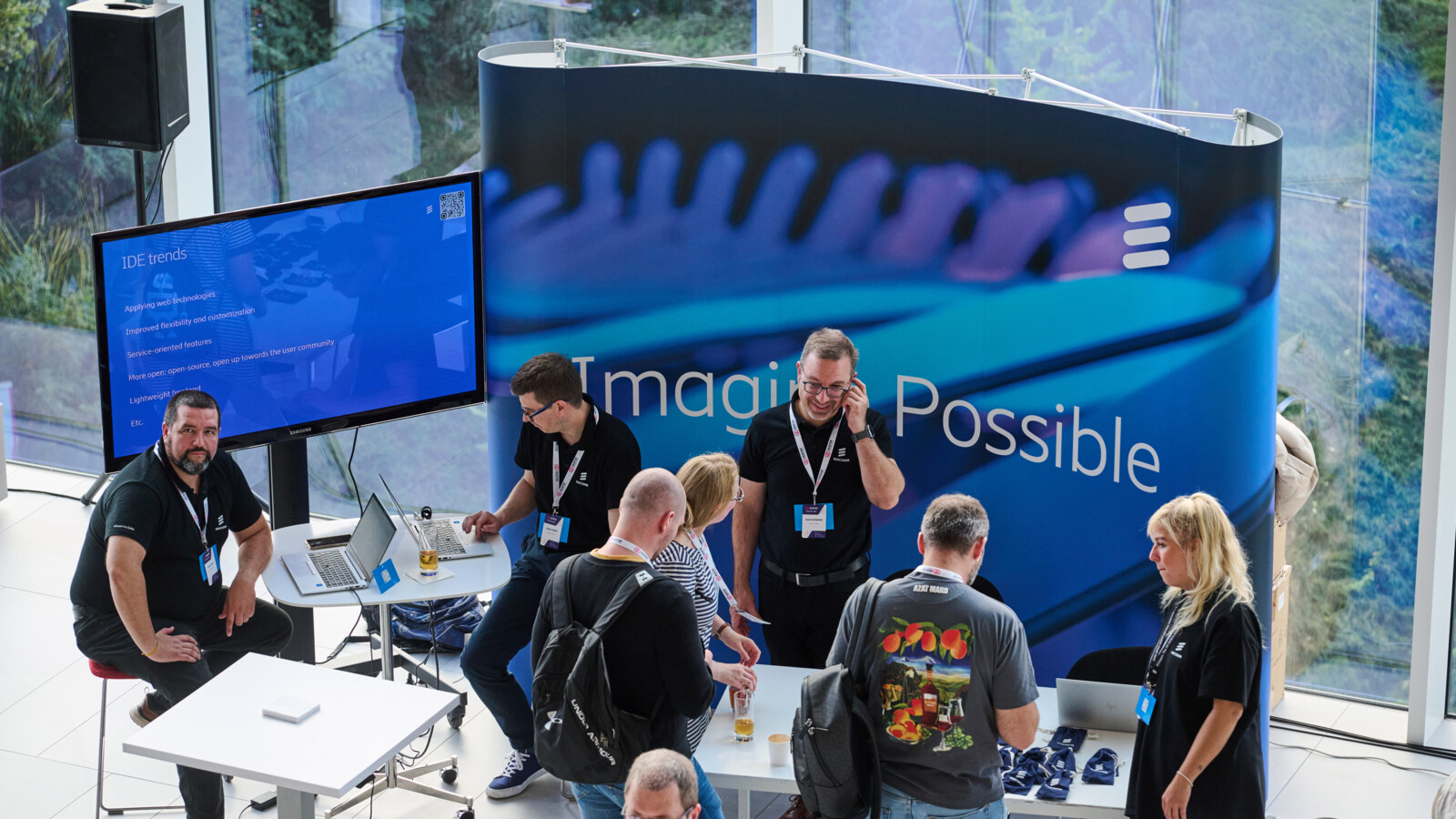 people standing in a booth in a conference