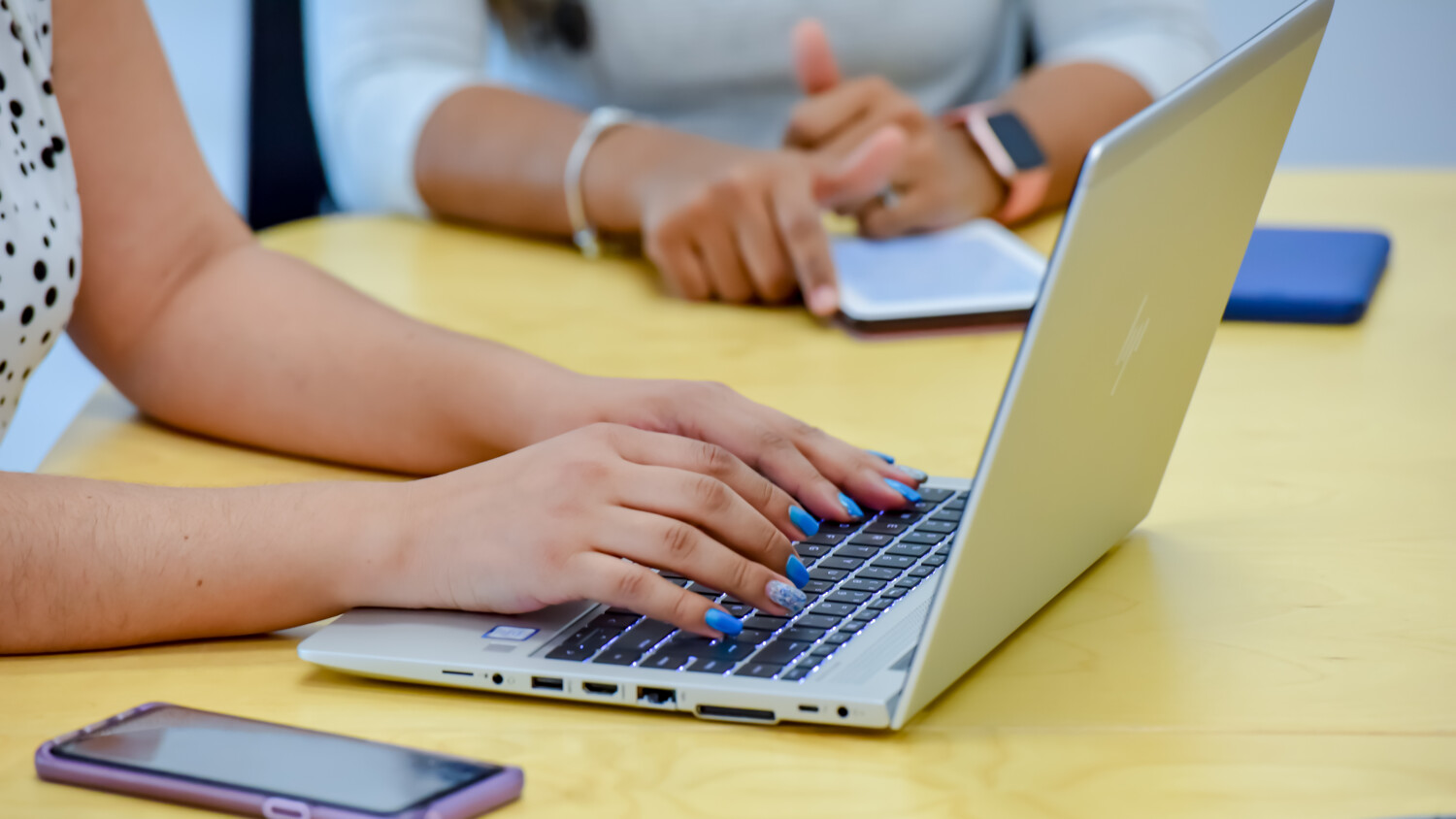 person using laptop during a meeting.