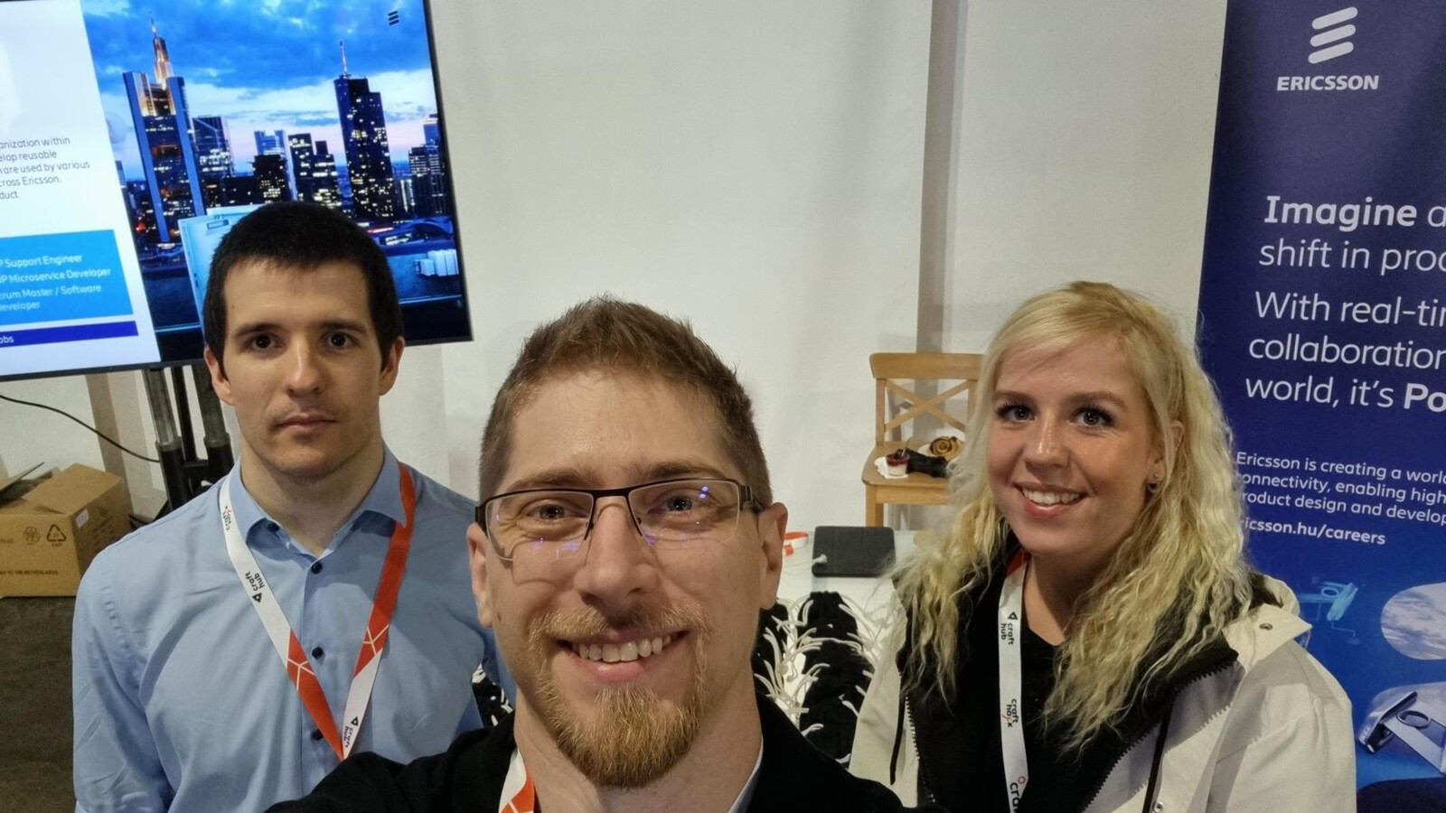 young people standing in a booth in a conference