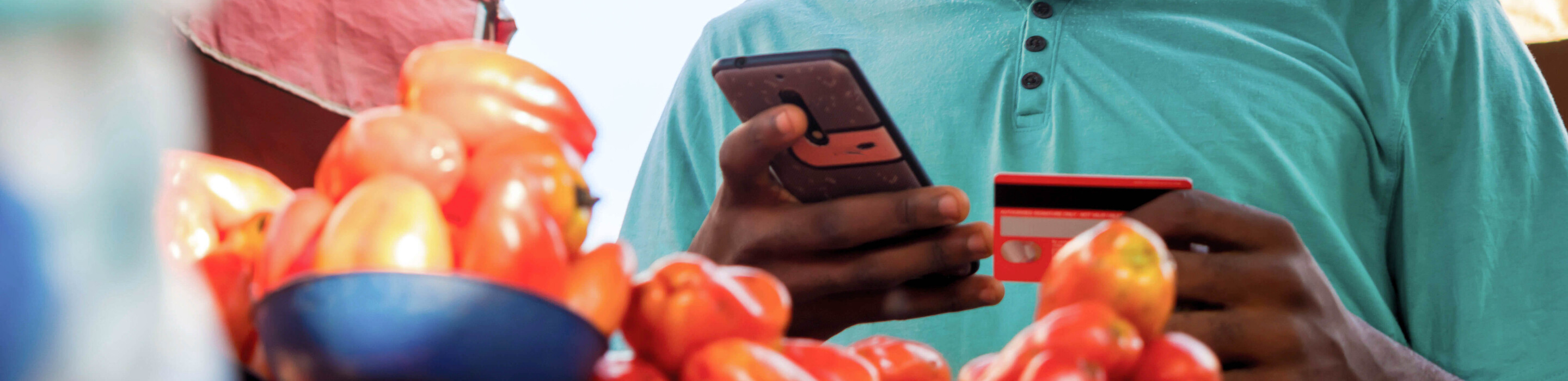 Young man using credit card in market