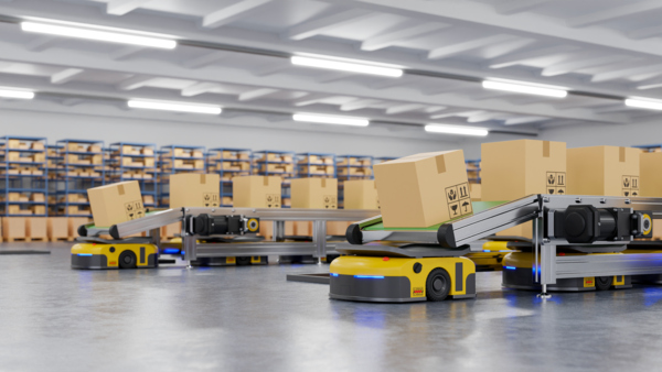 Automated robots move boxes in a modern warehouse space.