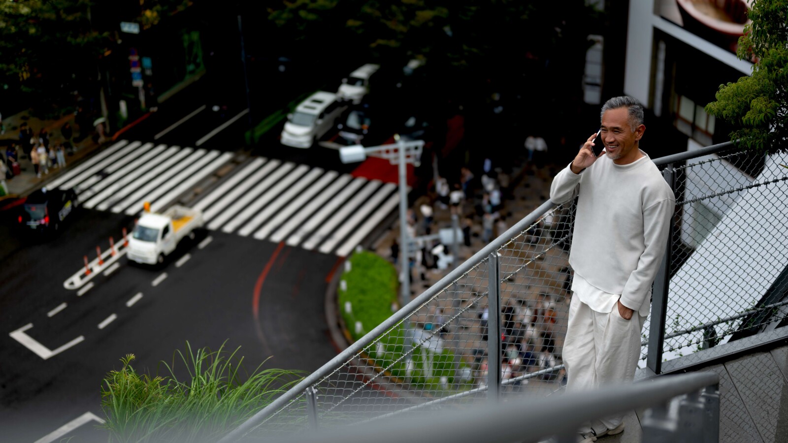 Man holding a smartphone outdoors.