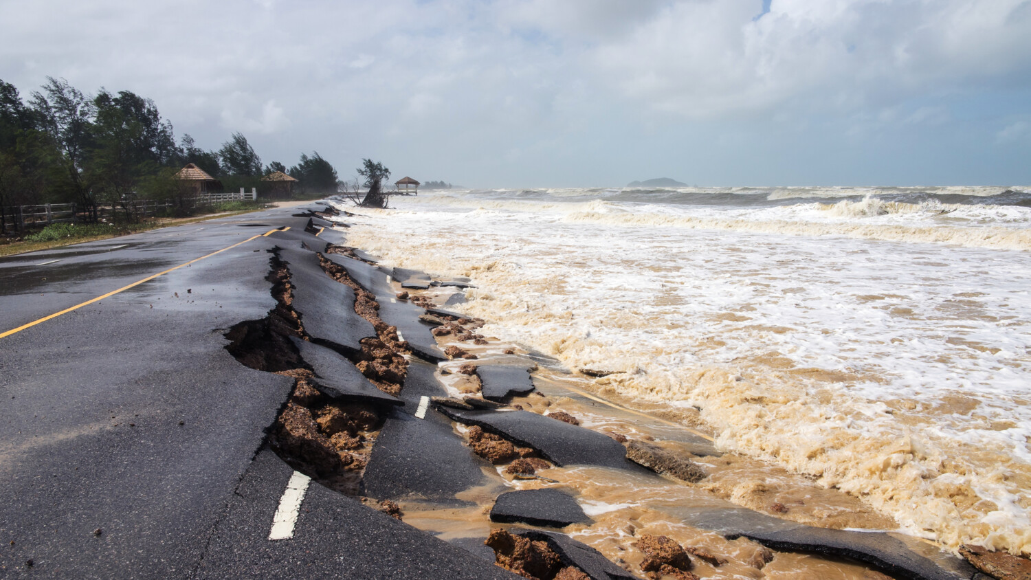 Road being damaged by flood in Pakistan.