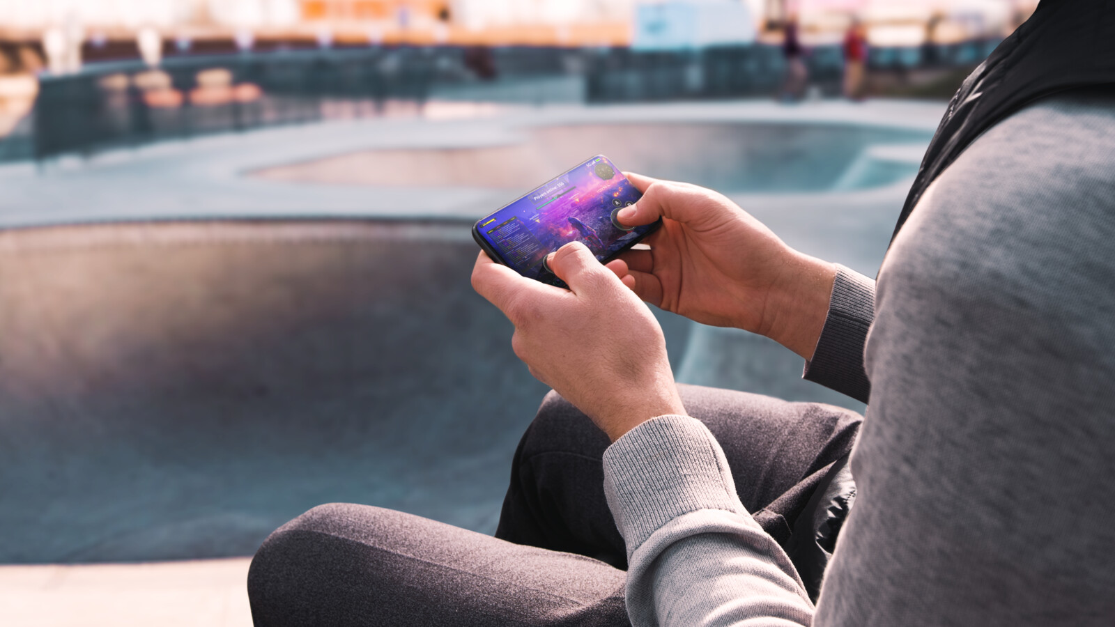 A woman using her phone for online gaming.