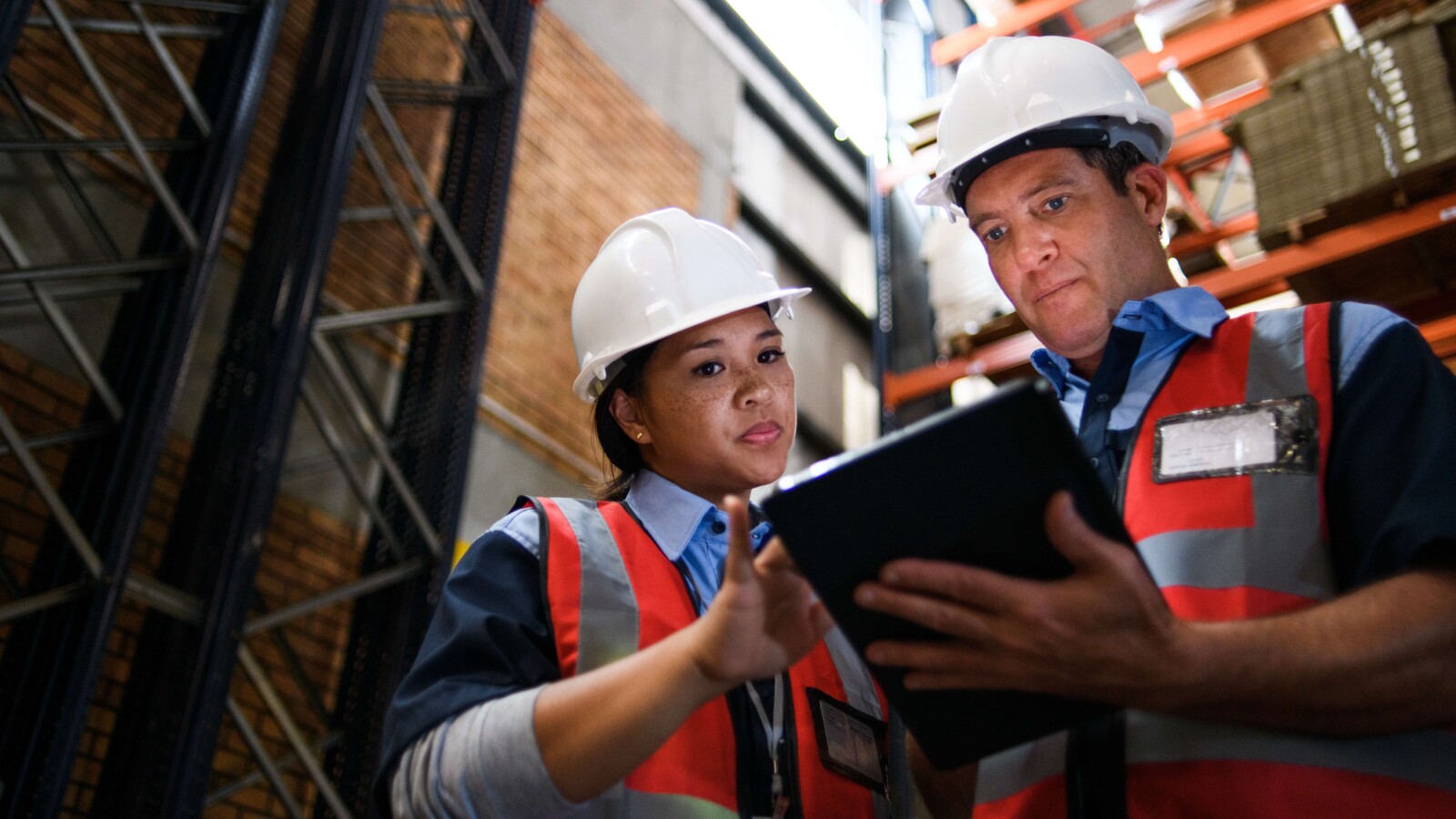Woman and man discussing about tracking shipping goods with 5G.