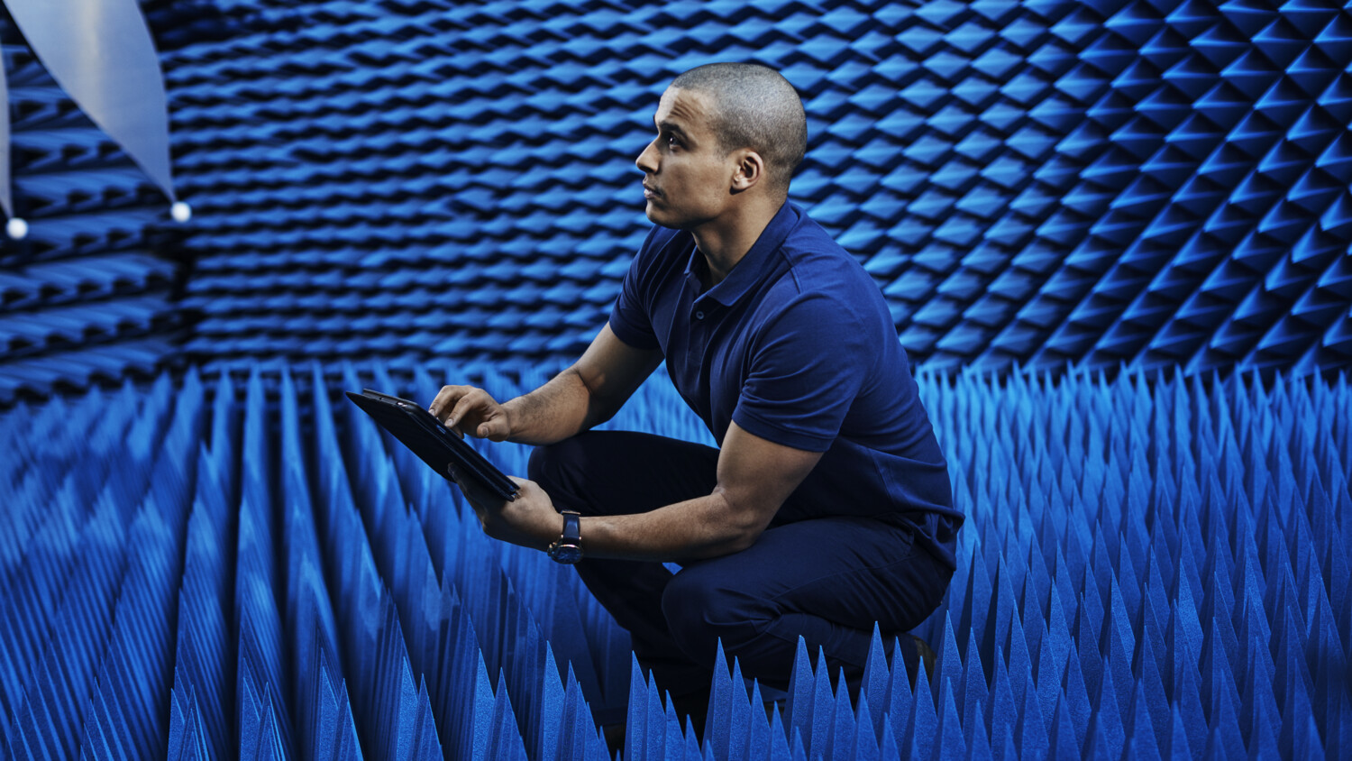 Man in testing room with tablet.