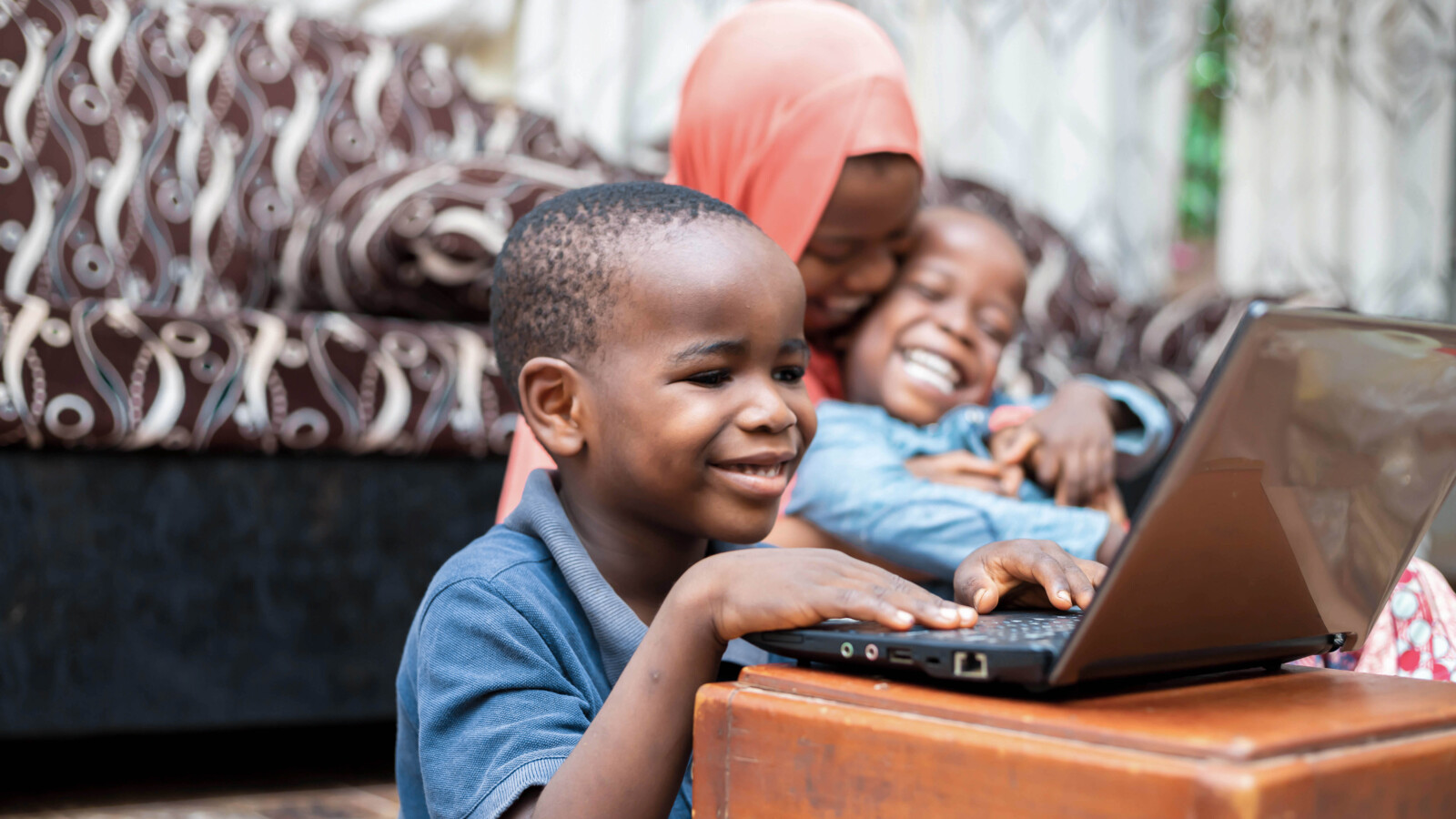 Young kid having online class at home.