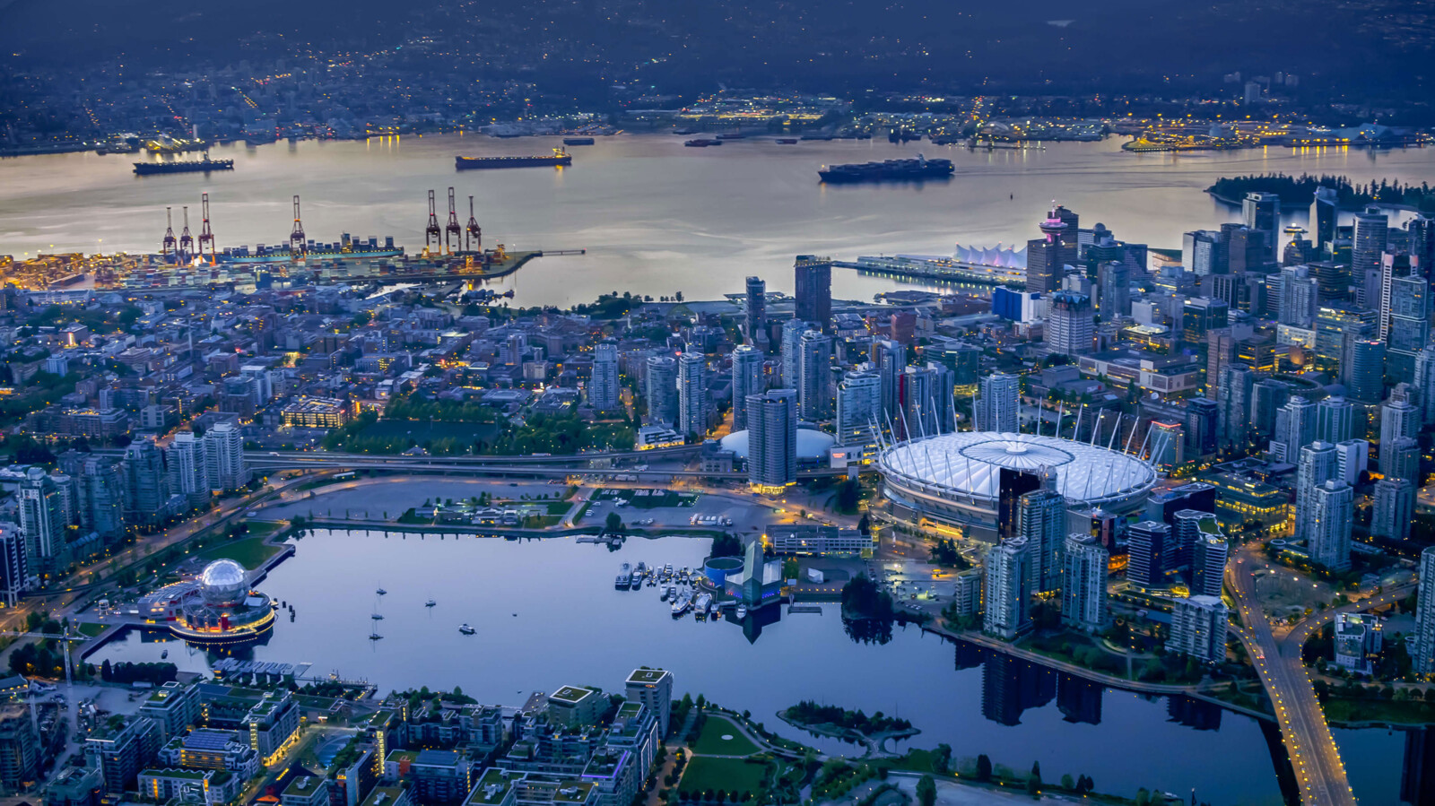 City in the dawn with stadium, harbor, and water areas.