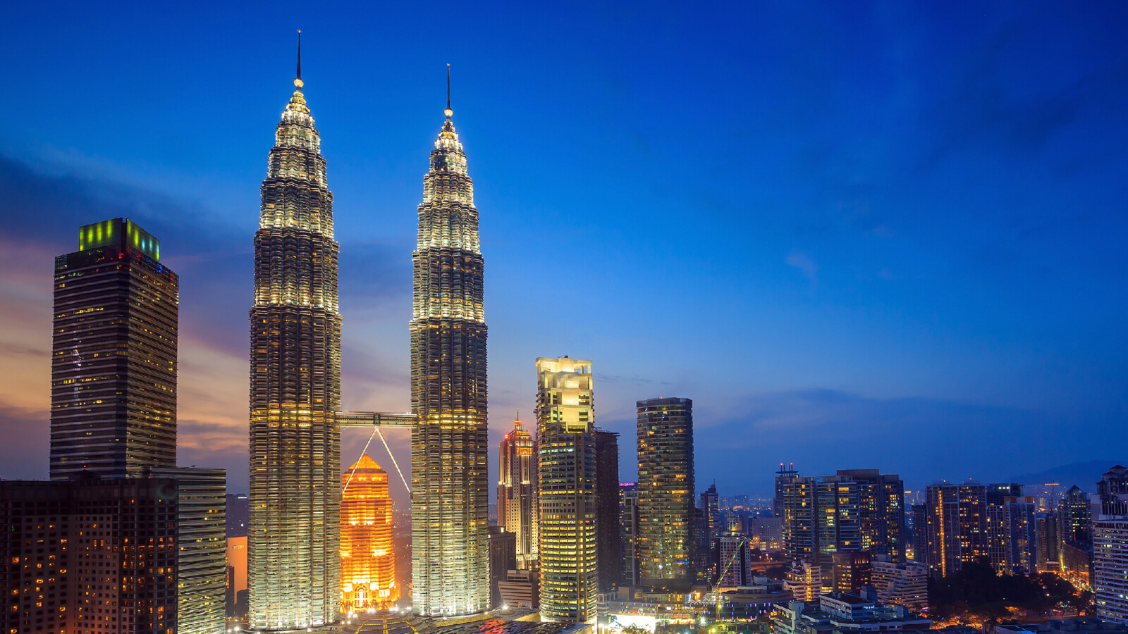 A skyline of the Kuala Lumpur business district at night.