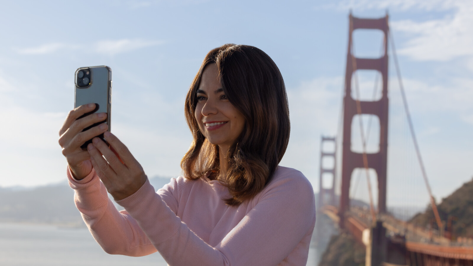 Woman taking a selfie at Golden Gate bridge.