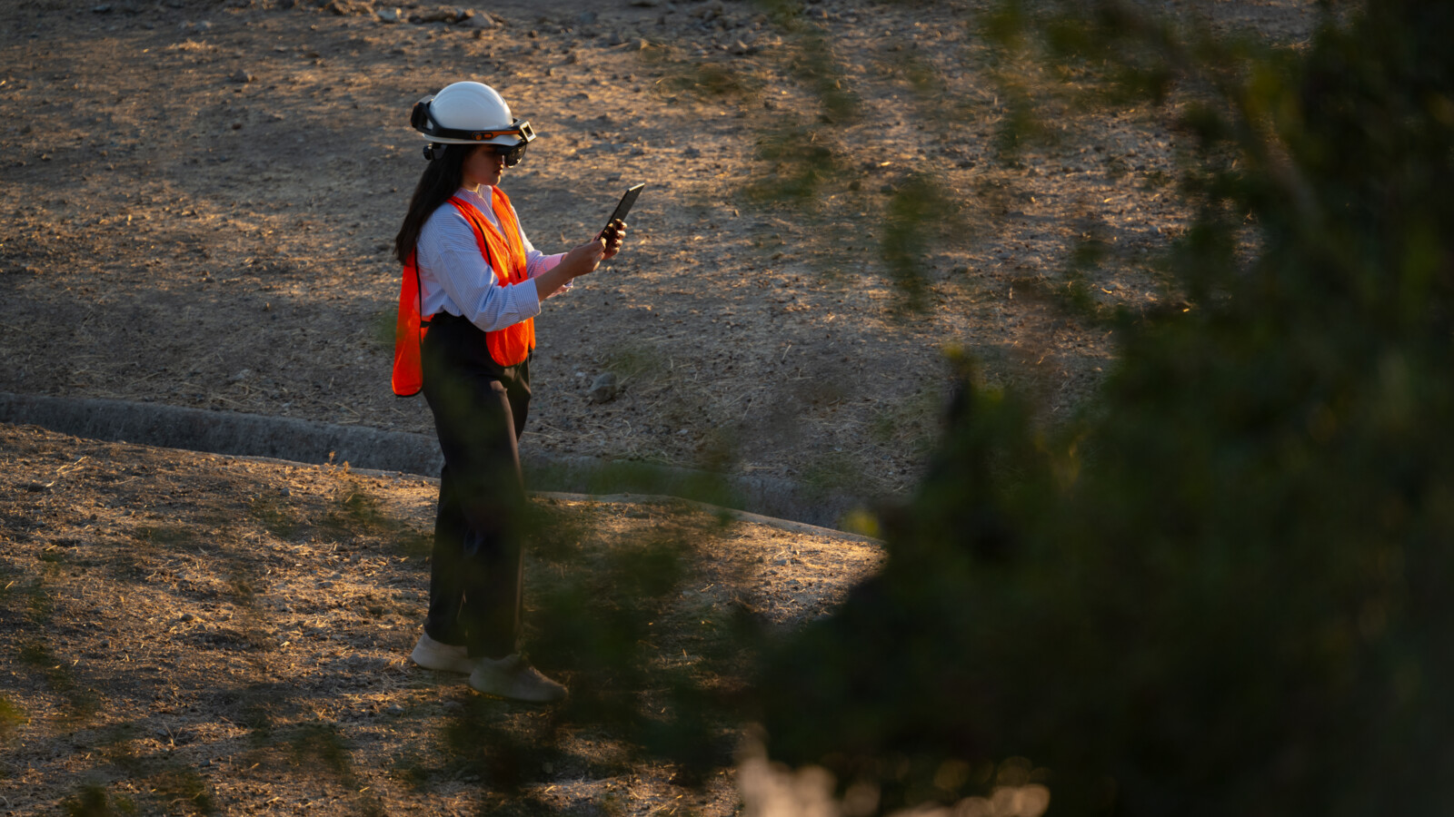 Woman working on laptop in rural area