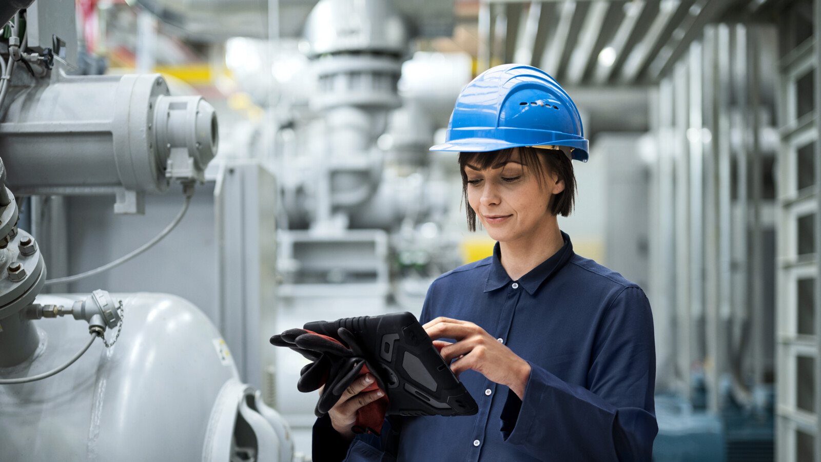 Engineer with tablet in a factory.