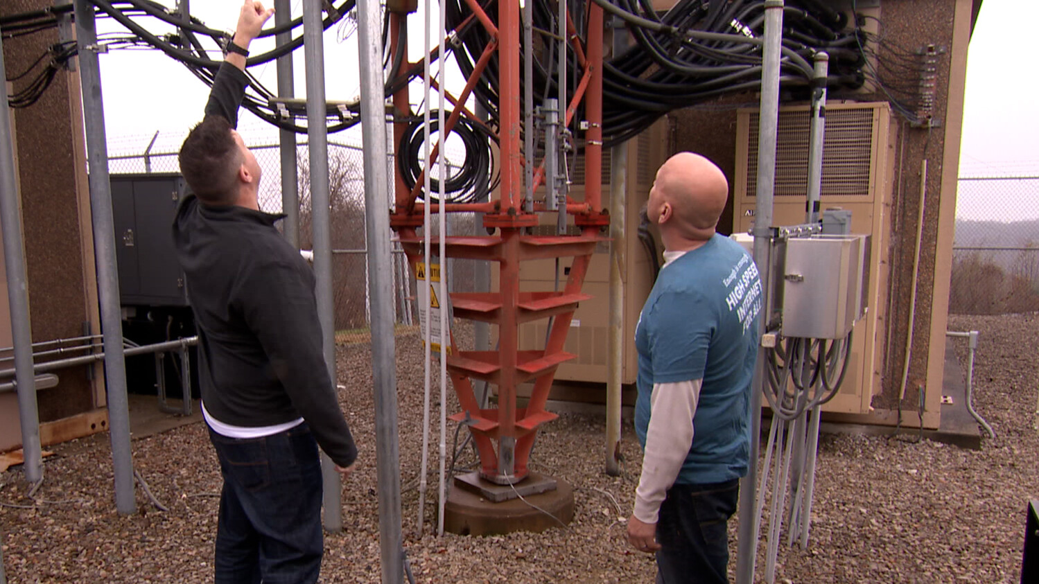 technicians inspecting radio tower