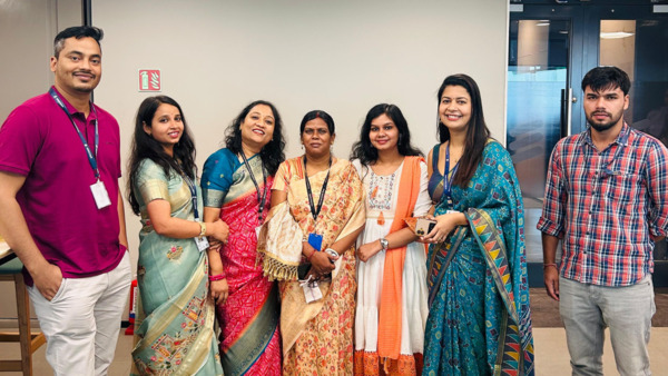 Anima Dey and her colleagues wearing traditional clothing