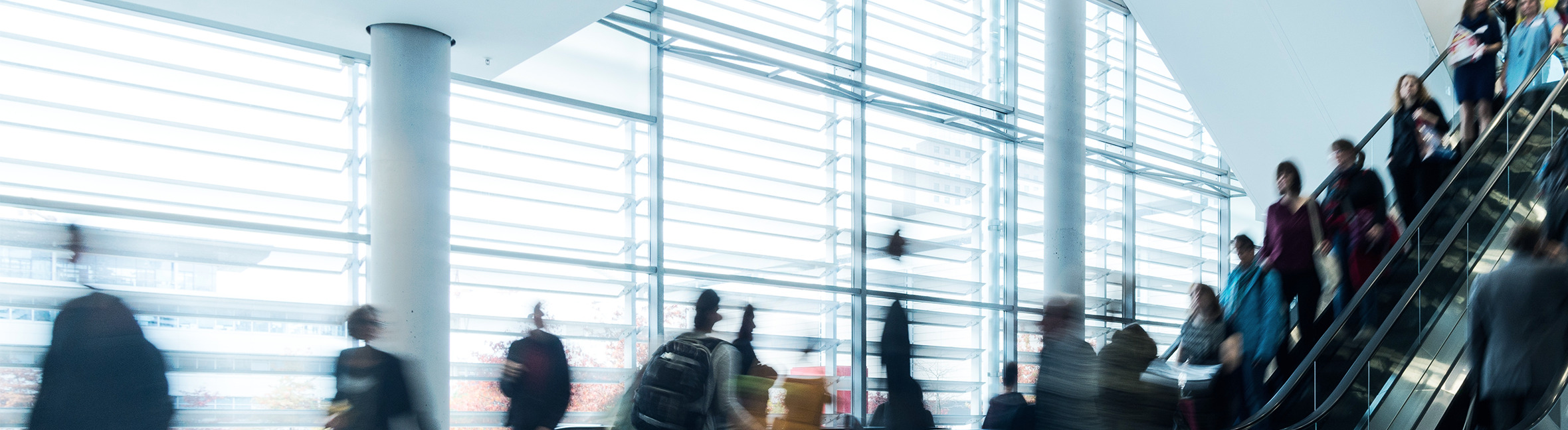 People in an airport escalator.