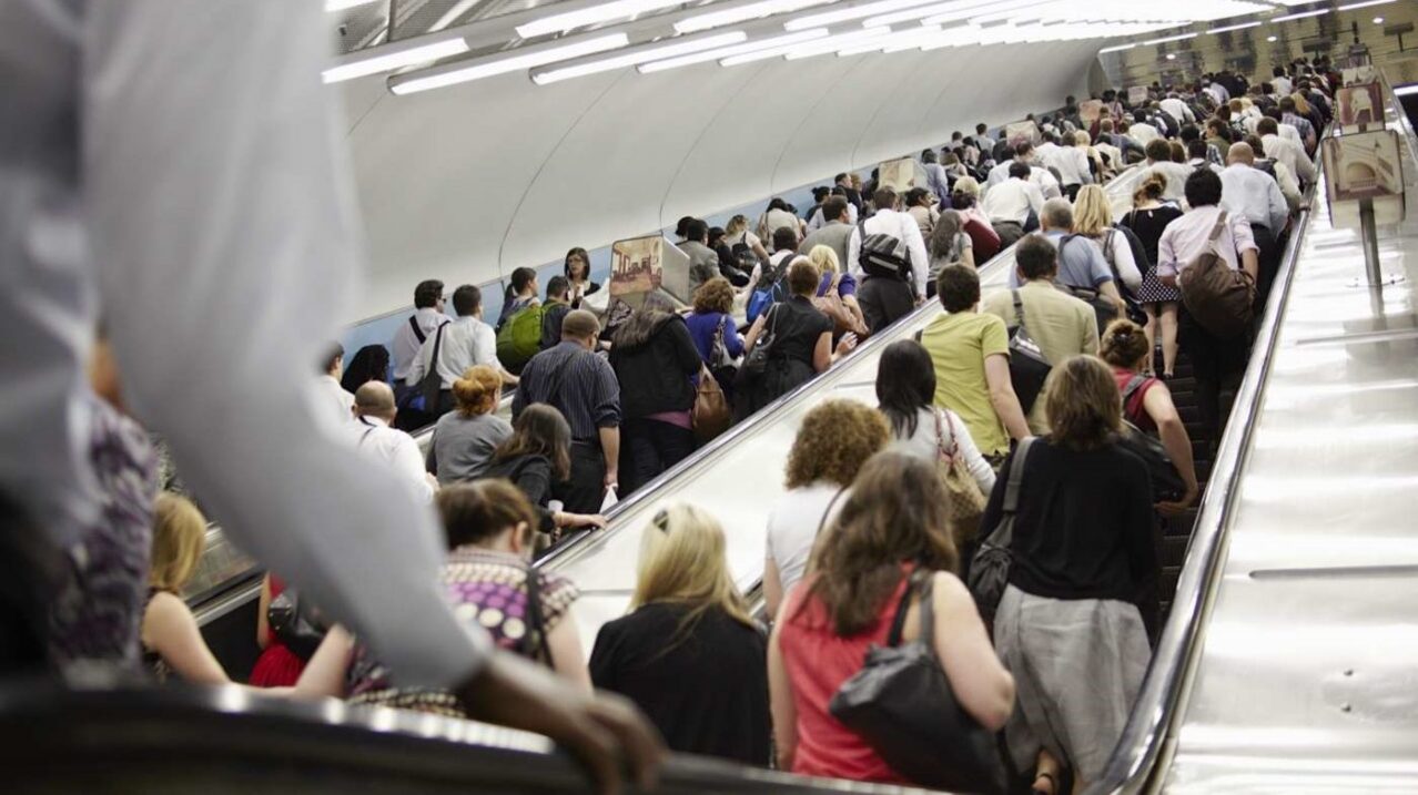 Passengers on an escalator. Modernizing equipment lets smart airports improve their customer experience.