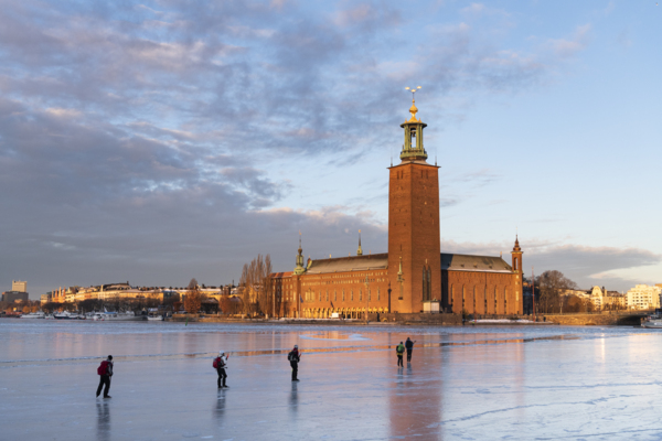 People ice skating outside Stockholm City Hall in Winter