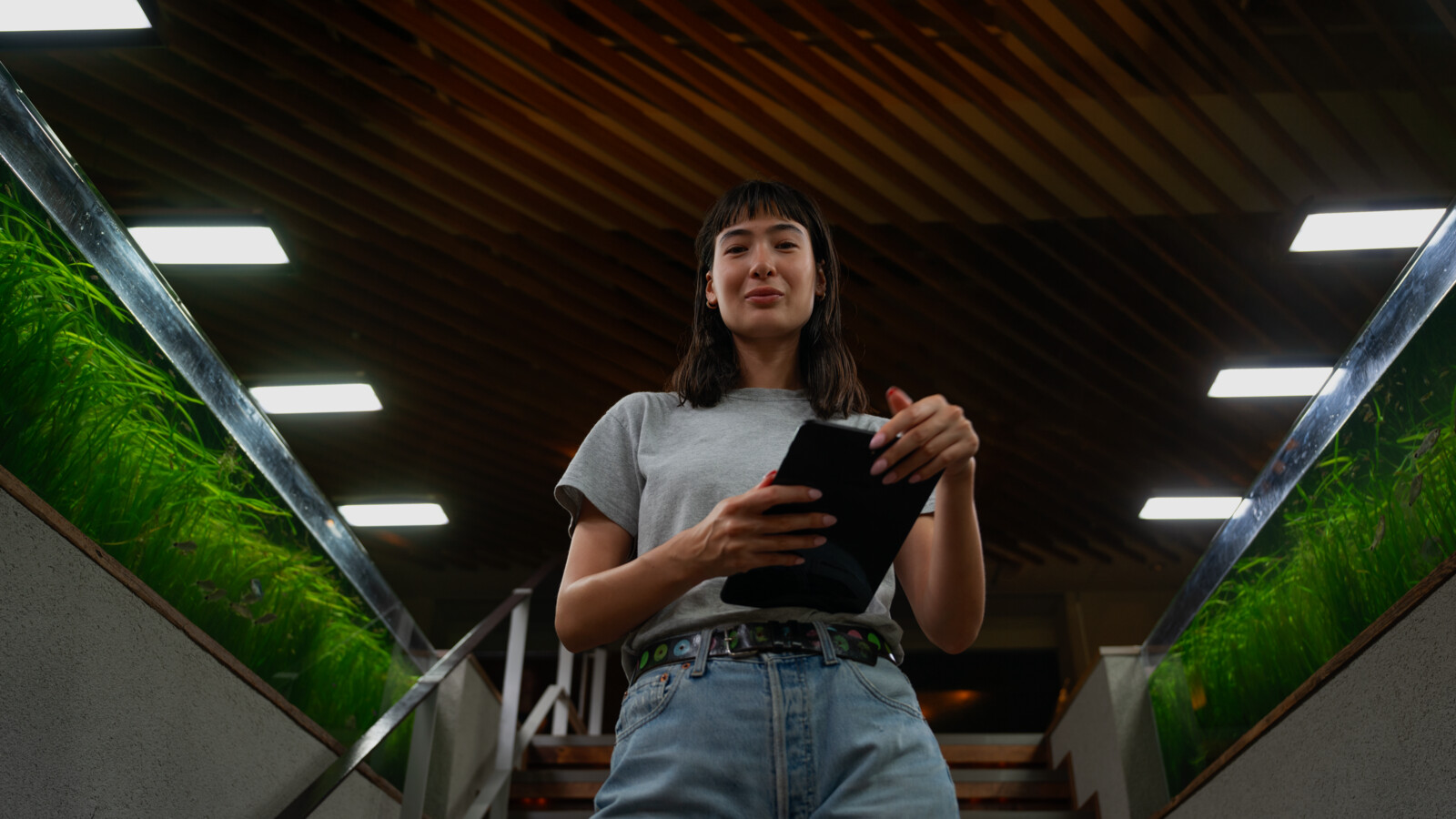 Woman standing in sustainability facility holding a tablet