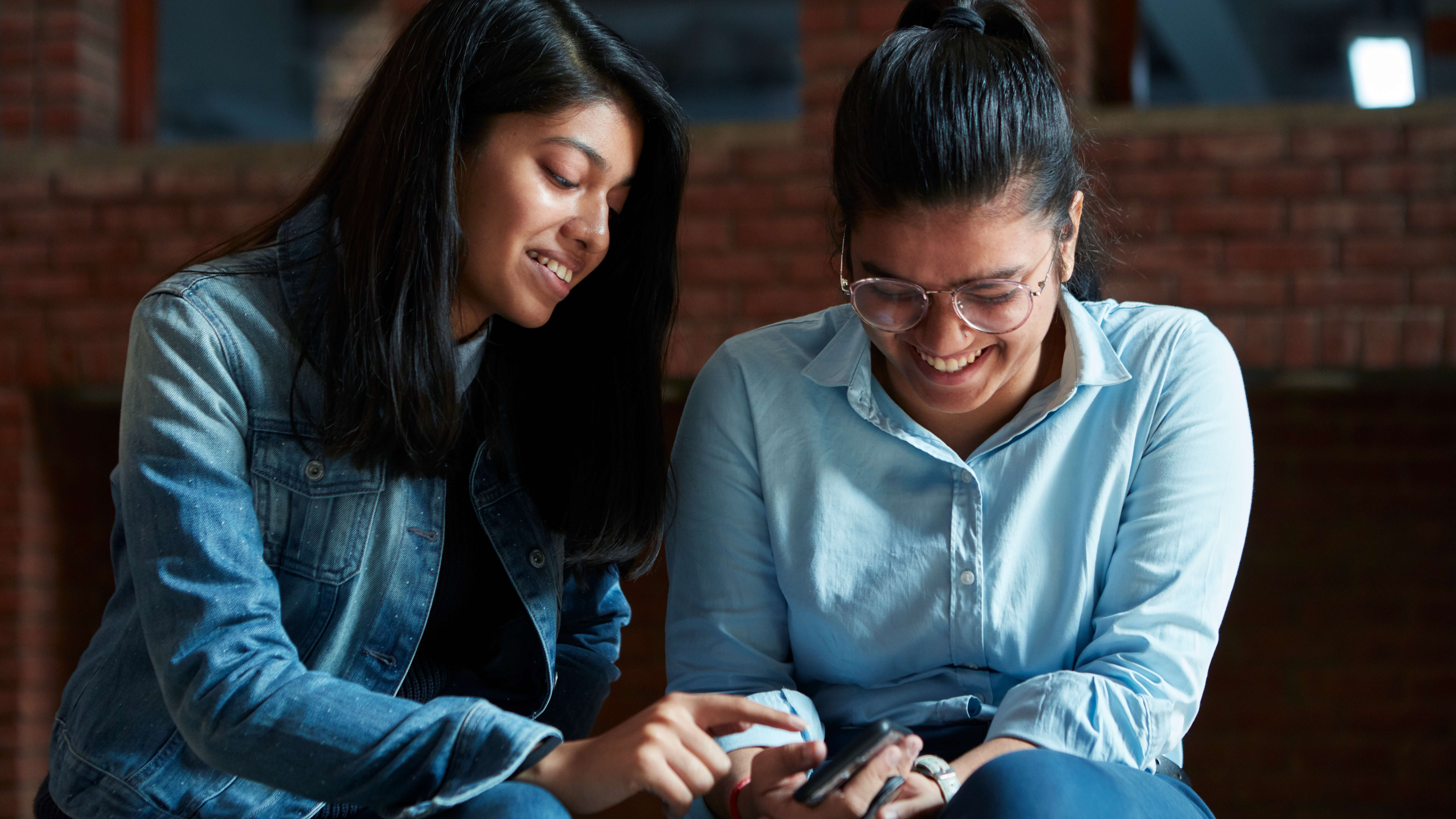 Two interns looking at a device.
