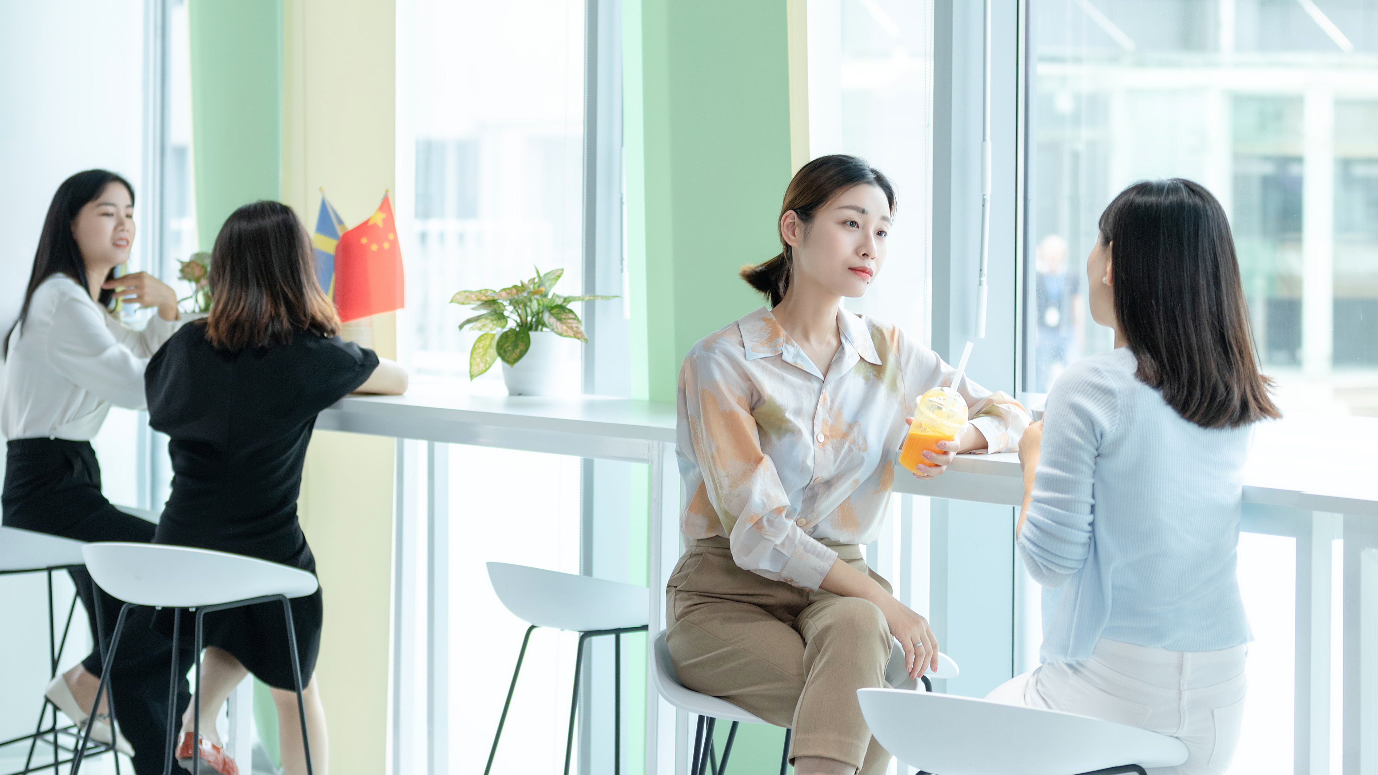 Women employees talking in the office.