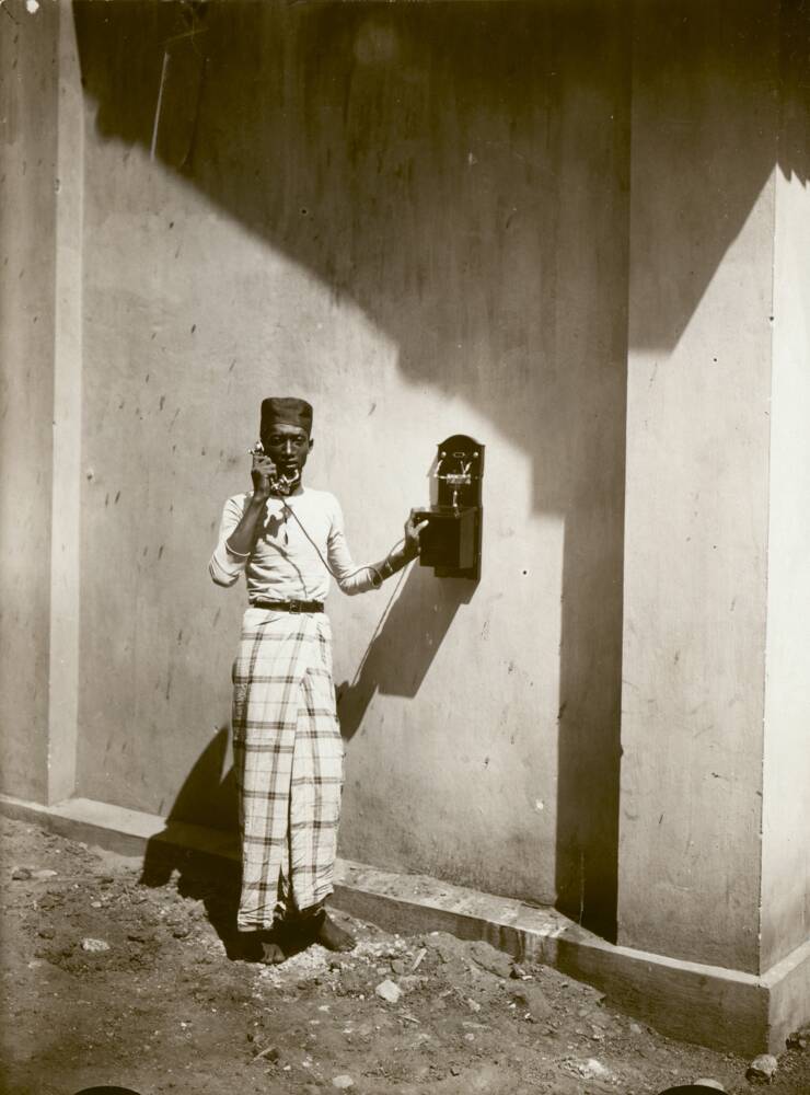 Phone call in the street, Indonesia, 1926.