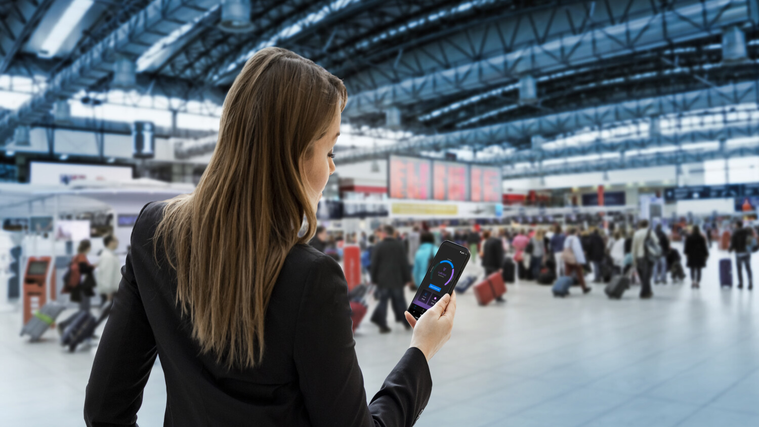 Woman at airport using mobile phone.