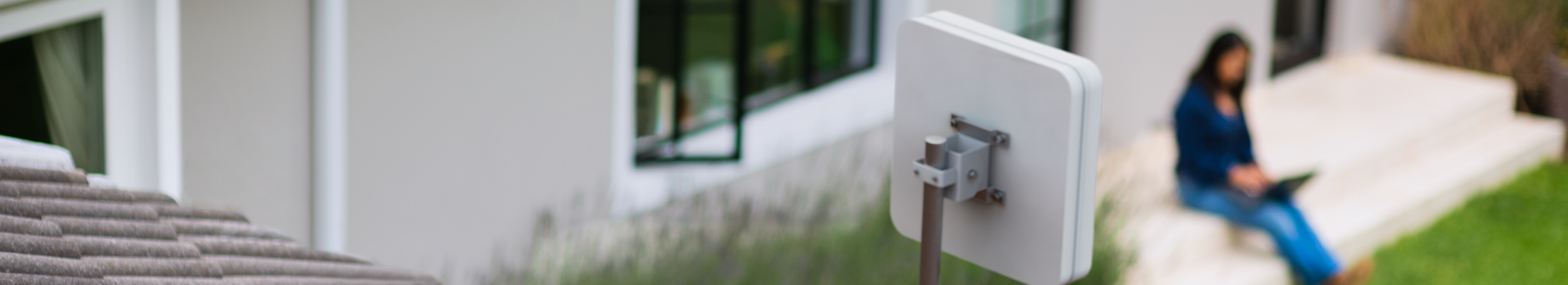 Woman working outdoors using FWA CPE router
