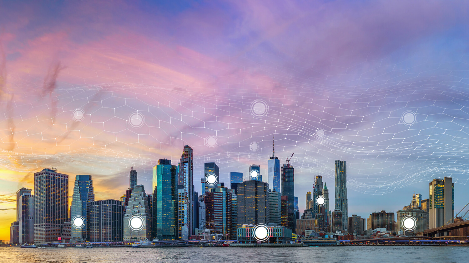 City skyline with digital network overlay at sunset.