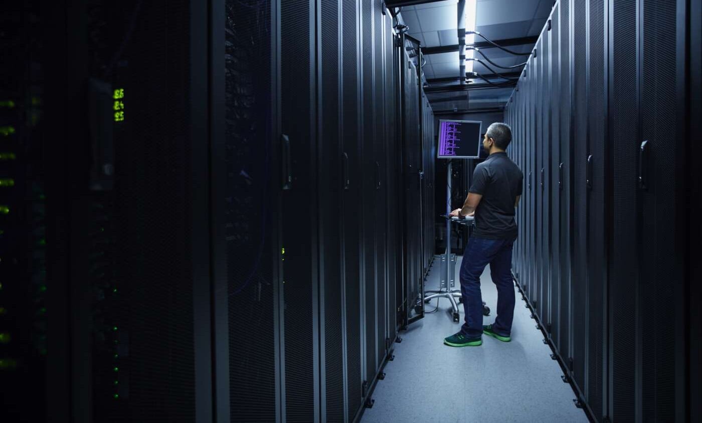 Man in server room with 5G security - enabling a trustyworthy 5g Network