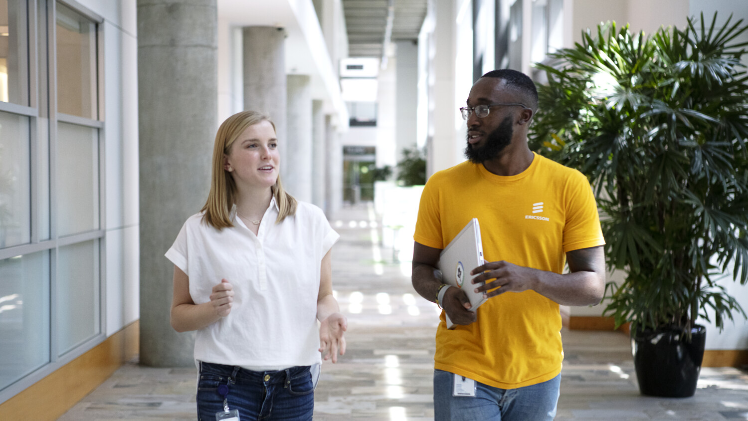 Two colleagues walking and talking.
